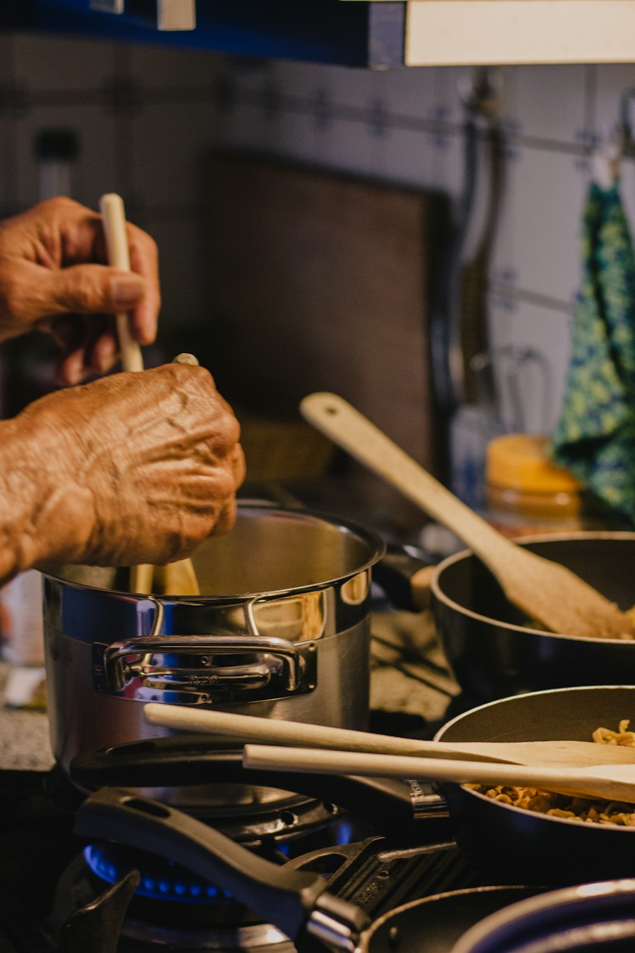A cook holding a wooden rolling pin over a work surface