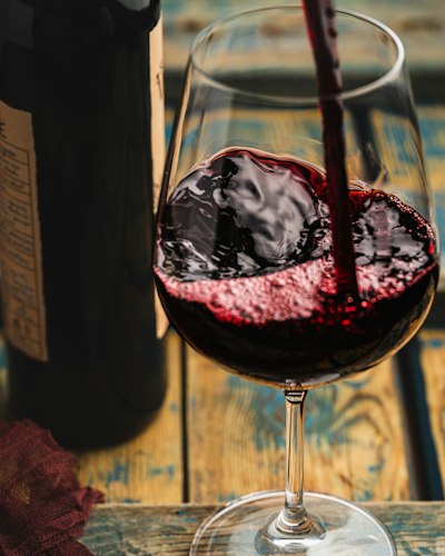 Red wine being poured into a glass