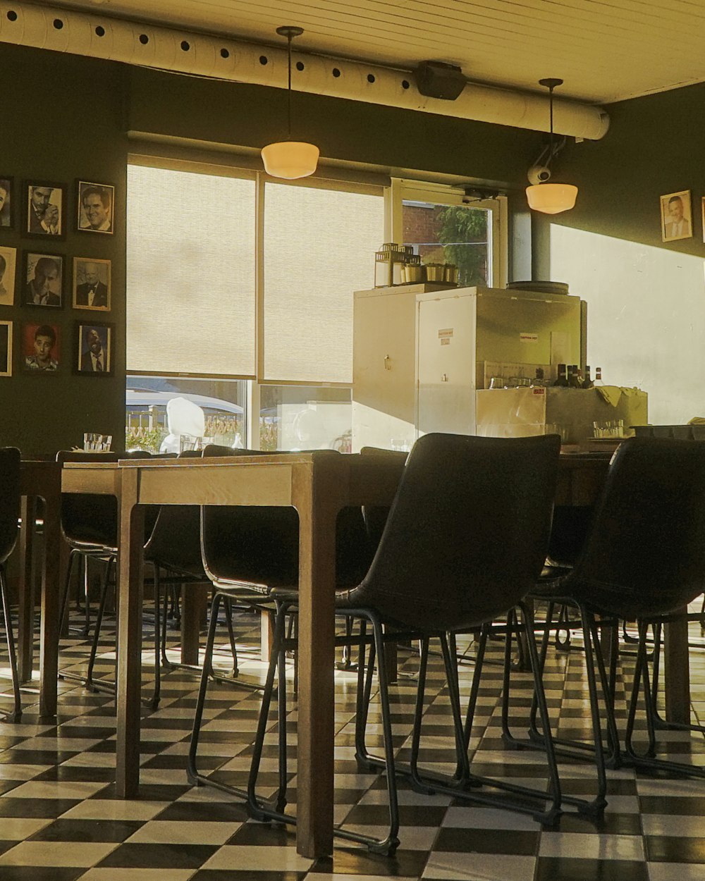 Warm, golden evening light across the tables and chairs of an Italian dining room